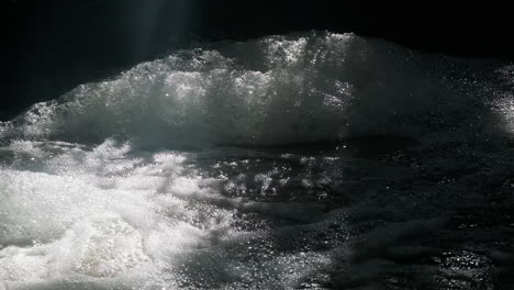 bubbly water in a stream making massive piles of foam