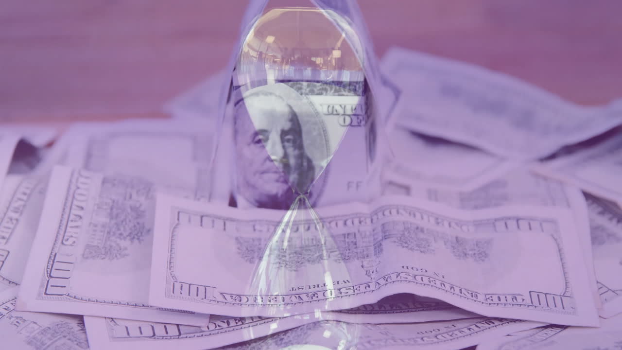 Animation of hourglass over dollar banknotes