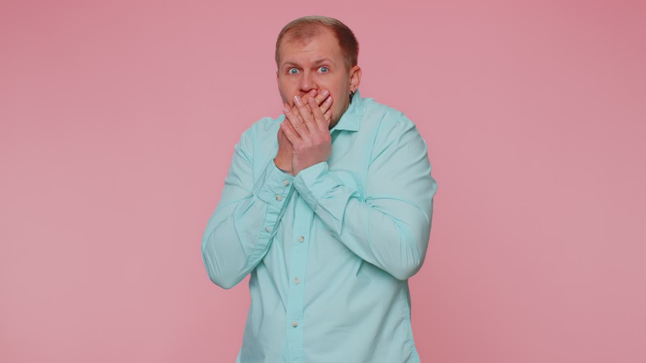 Scared fearful depressed man expresses his fear and waves his hands away from danger waving no