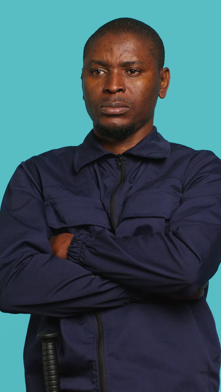 Serious African Man in Uniform with Crossed Arms