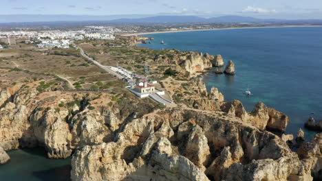 Ponta-da-Piedade-Lagos-Lighthouse-And-Rock-Formations-Around-Headland-In-Lagos,-Algarve,-Portugal