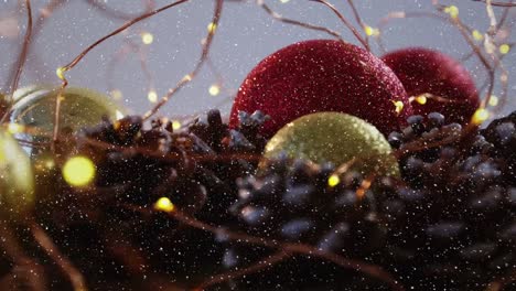 Video-composition-with-falling-snow-over-baubles-in-nest