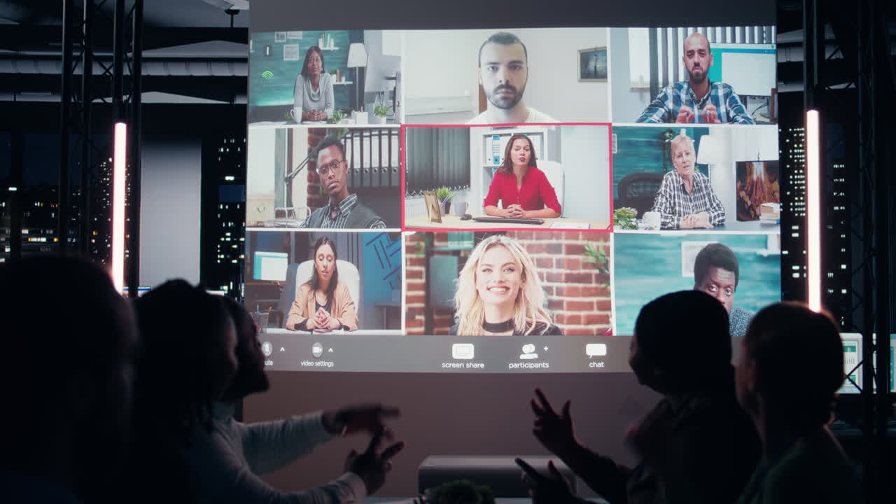 Multiethnic group attends a digital meeting from the office at night