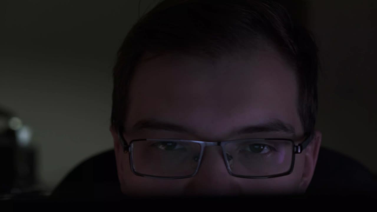 Person working on a laptop at night