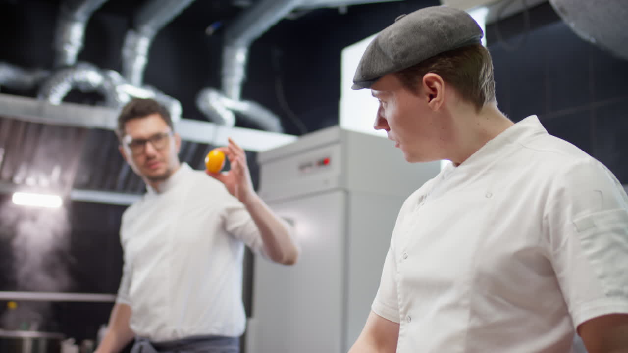 Restaurant Chef Cooking and Talking with Colleague