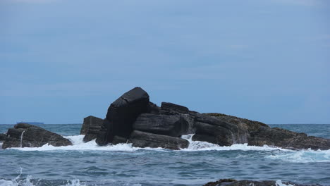 ocean waves crashing on rocks at the beach in sri lanka