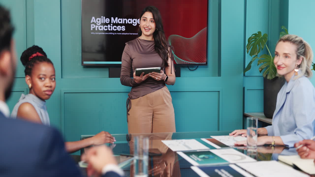 Businesswoman Presenting Agile Management Practices to Colleagues in a Meeting