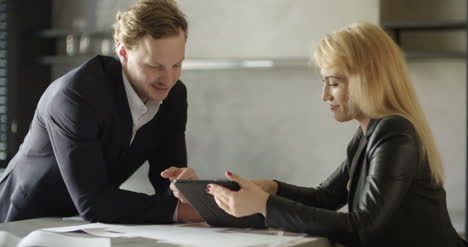 Businesswoman-And-Businessmam-Having-Successful-Conversation-In-Meeting-Room-