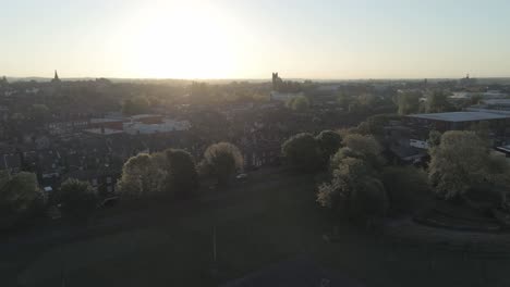 drone aerial view above british sunrise typical housing silhouette skyline rising