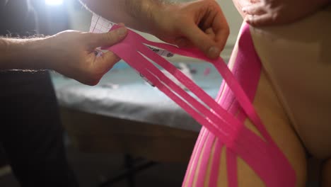 applying kinesiology tape to the thigh