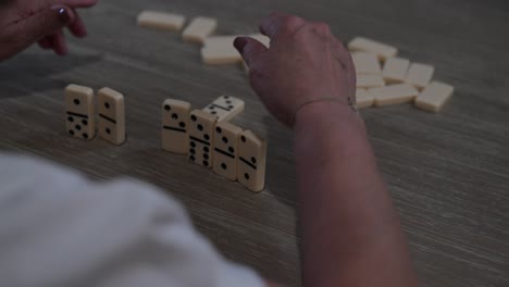 elderly woman playing dominoes late at night