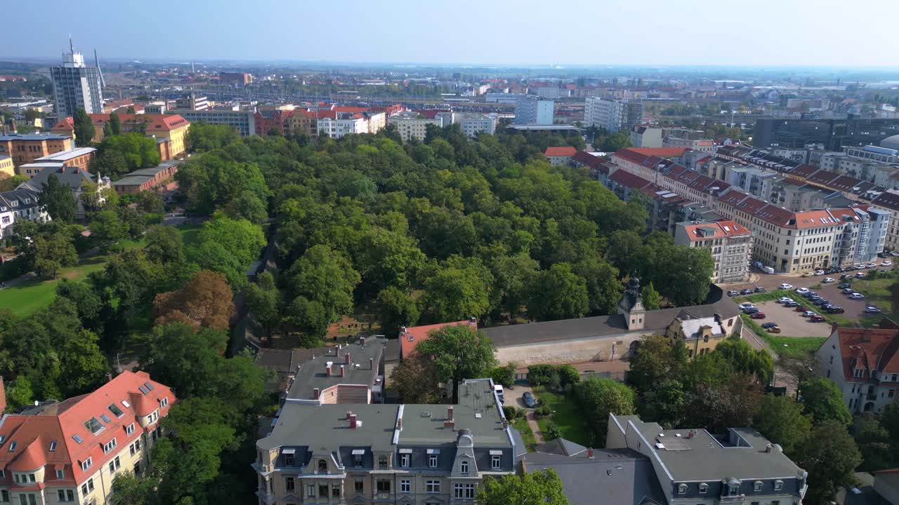 The stadtgottesacker, a historic cemetery in halle, germany, is a peaceful green oasis in the heart of the city. Marvelous aerial view flight panorama orbit drone