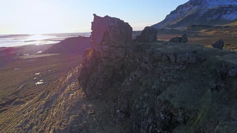 Rocky-Formation-with-Aerial-Drone-Orbital-Shot-and-Sunlight-Behind