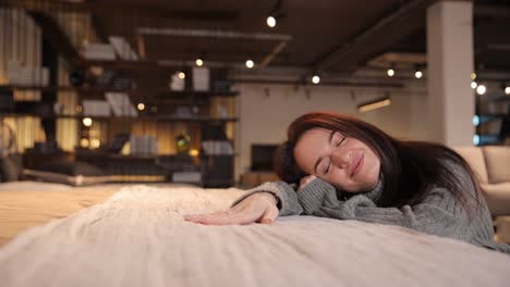 beautiful female customer choosing new bed linen to buy at furnishings store. bedding concept. high quality 4k footage