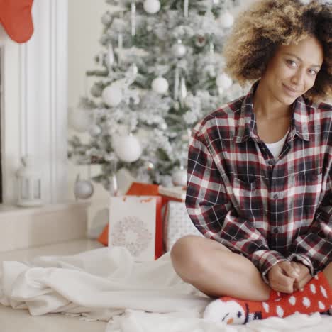 trendy young woman in front of a christmas tree