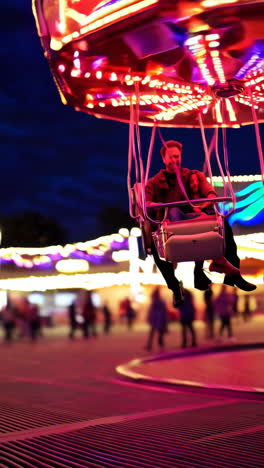 people enjoying a swing ride at a night fairground