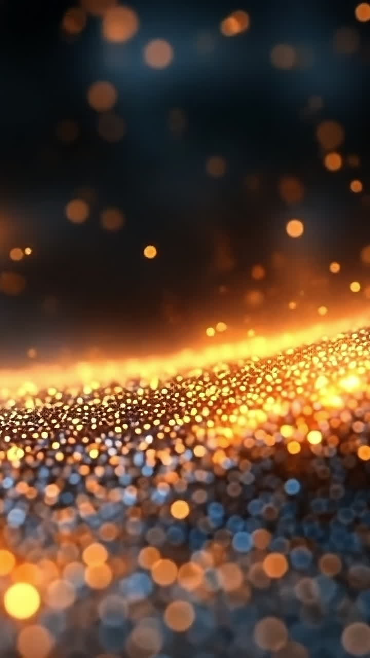 Glowing particles form waves. Golden and blue particles form a flowing wave, highlighting a dynamic blend of color and light.