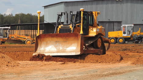 heavy caterpillar bulldozer working in quarry. yellow excavator moving ground