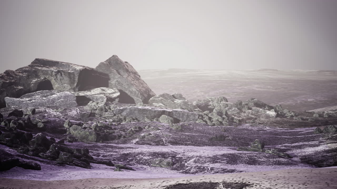 Vast barren landscape with rocky formations under a foggy sky at dusk
