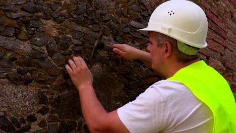 engineer take samples of old brick wall