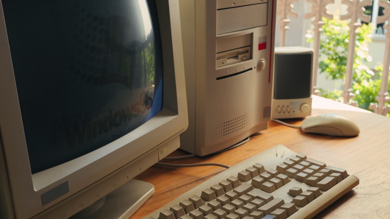 BARCELONA, SPAIN, 10 JUNE 2025. Man working and gaming on retro computer PC, IT engineer with vintage computer at home, using old fashion technology, close up of retro setup.