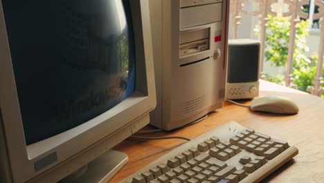 barcelona, spain, 10 june 2025. man working and gaming on retro computer pc, it engineer with vintage computer at home, using old fashion technology, close up of retro setup.