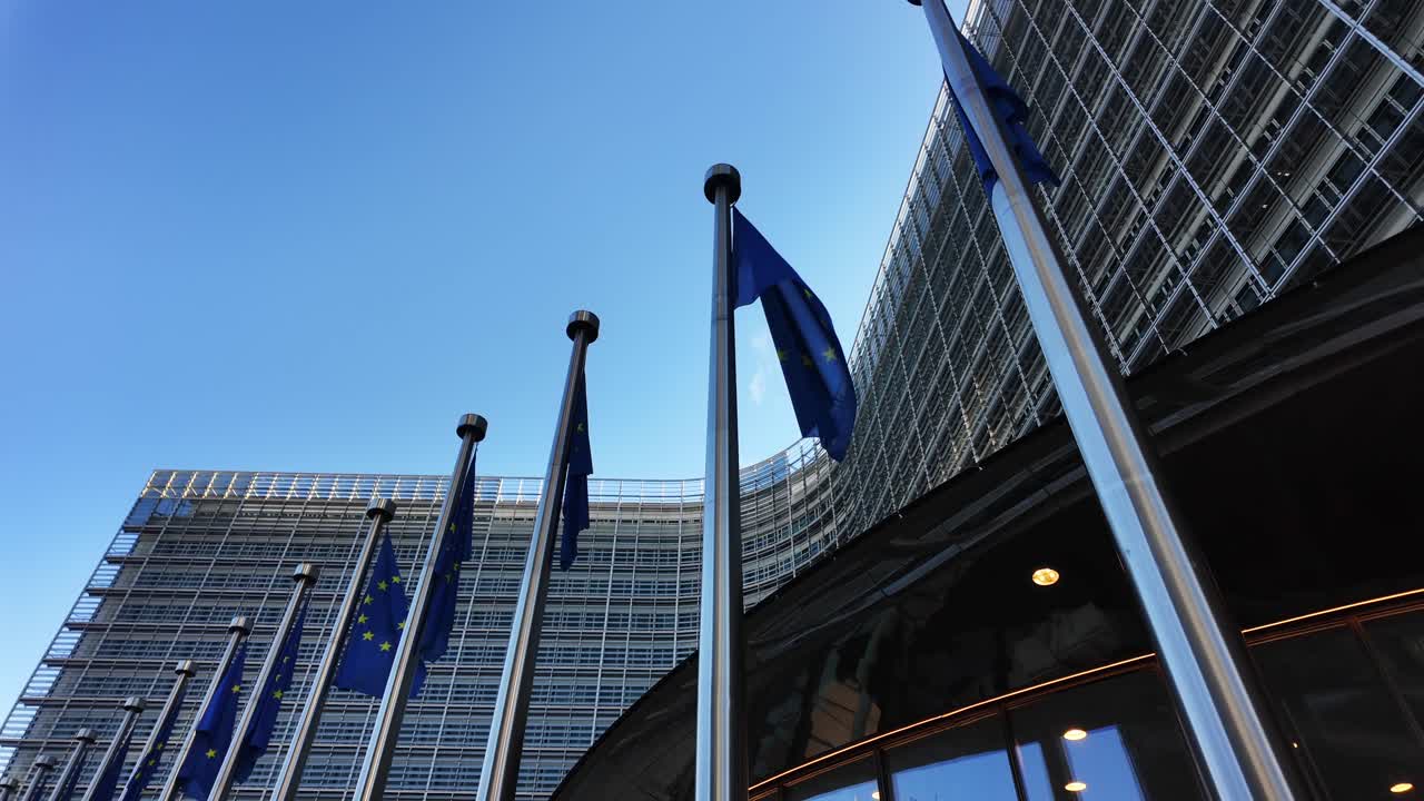 European Union flags waving outside Berlaymont headquarters in Brussels