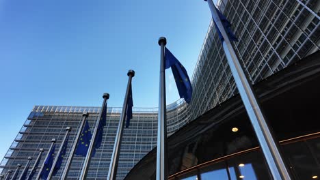 european union flags waving outside berlaymont headquarters in brussels