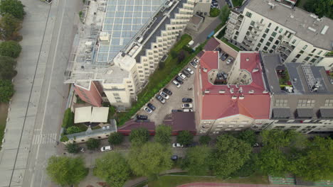 Aerial-top-down-of-old-industrialized-apartment-block-with-parking-cars-in-Krakow,Poland