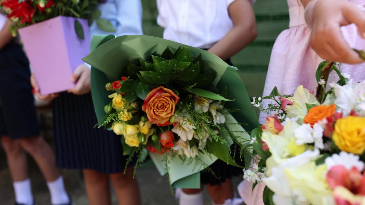 Bouquets of flowers held by children