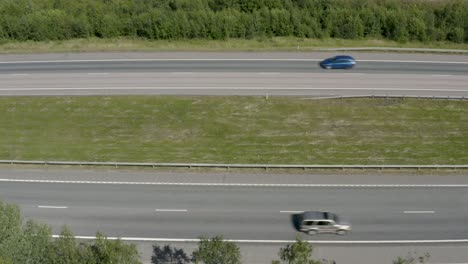 top down aerial view of cars passing quickly on a motorway in finland near kerava