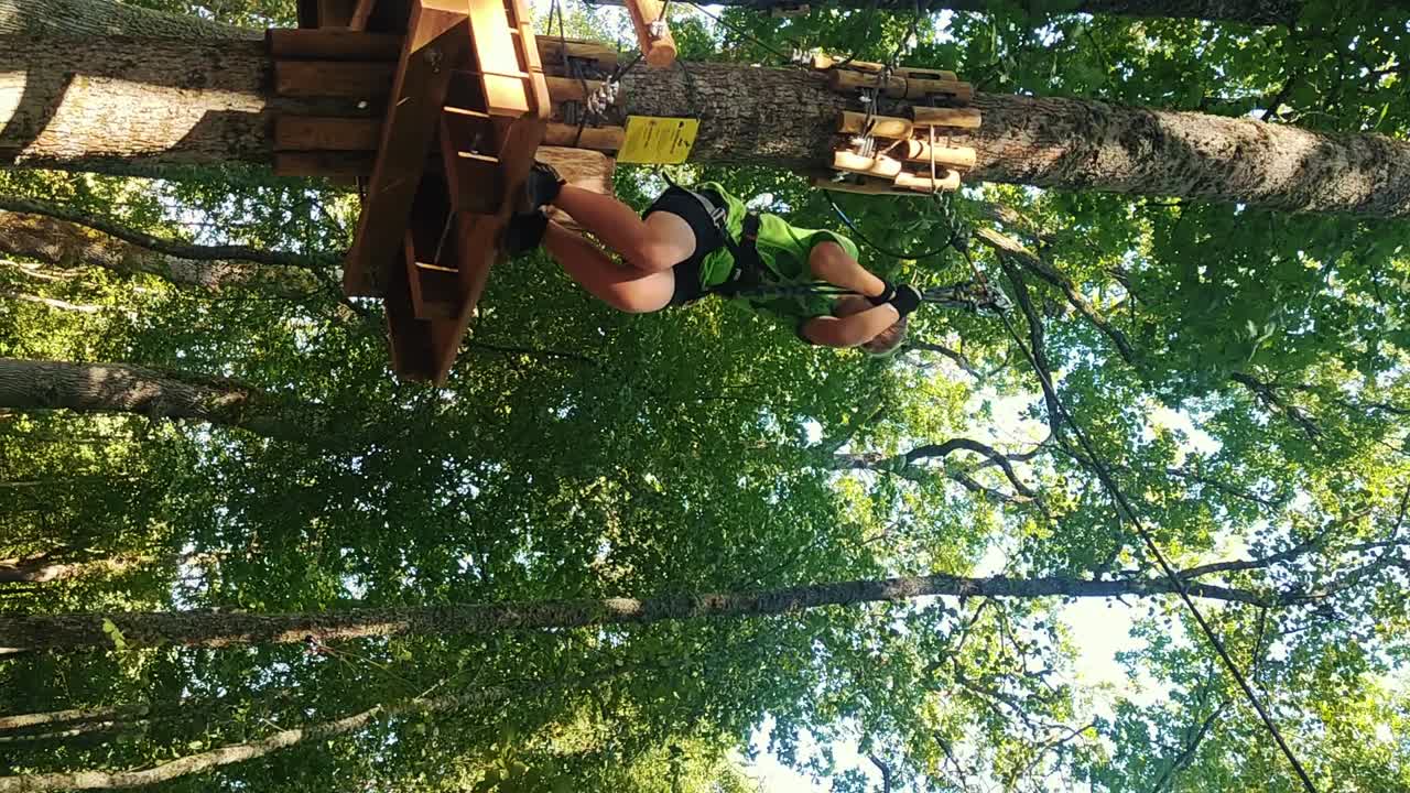 Pärnu, Estonia - 08 23 2024: Kid Enjoy Various Attractions Trails and Ziplines in Valgeranna Adventure Park Pärnu. An Amusement Park in the Treetops.