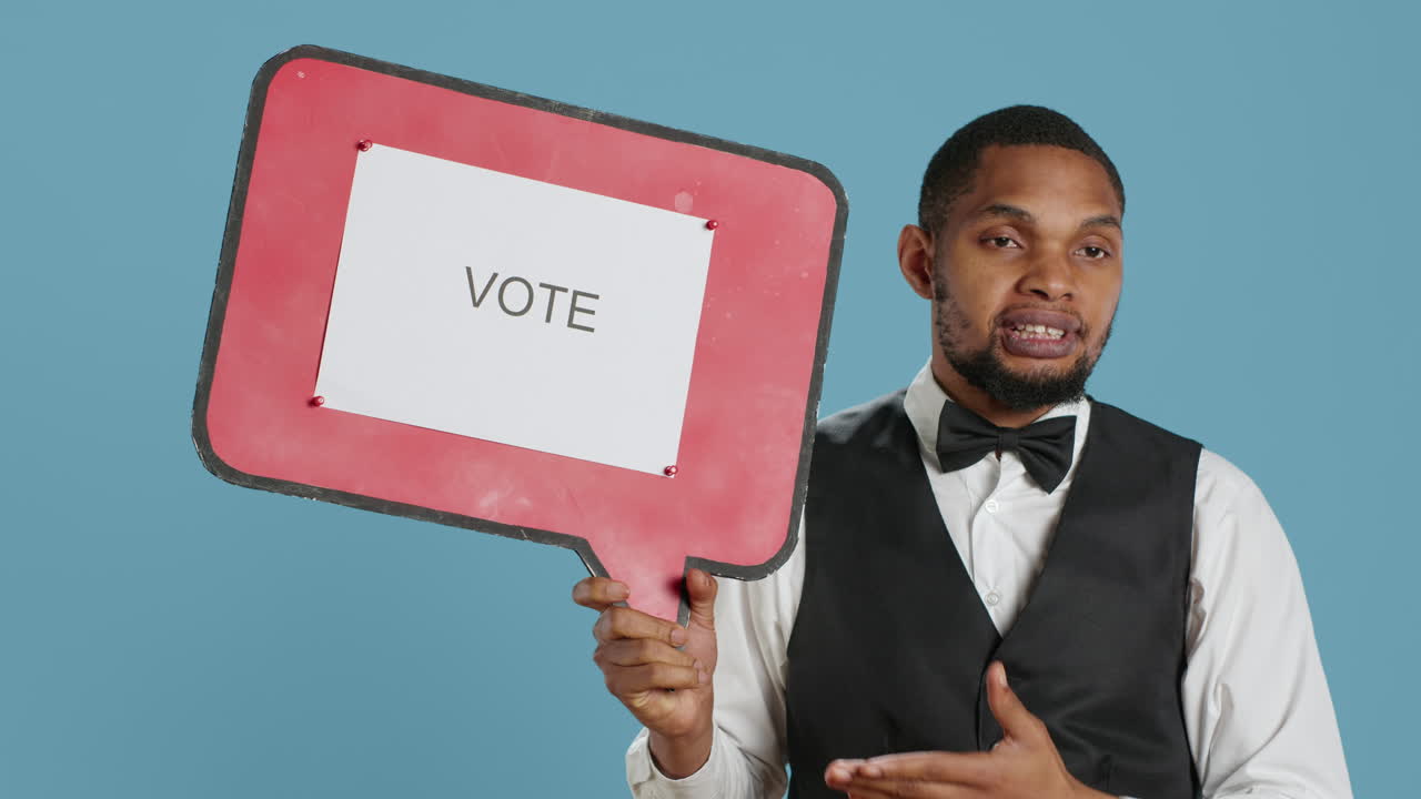 Hospitality industry worker shows speech bubble with political message