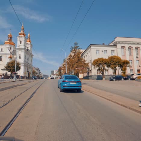 audi e-tron driving on road. full view of blue audi e-tron driving on road