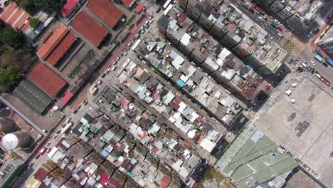 hong kong kowloon walled city, a densely populated slum, top down spin aerial view.