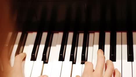 Close-up-of-woman-playing-a-piano