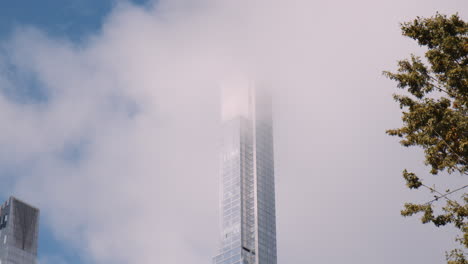 Skyscraper-Tower-Above-Clouds,-New-York-City-Manhattan,-Central-Park-Glazed-Modern-High-Rise-Architecture-and-Residential-Tall-Building-Covered-by-Clouds,-Low-Angle-View