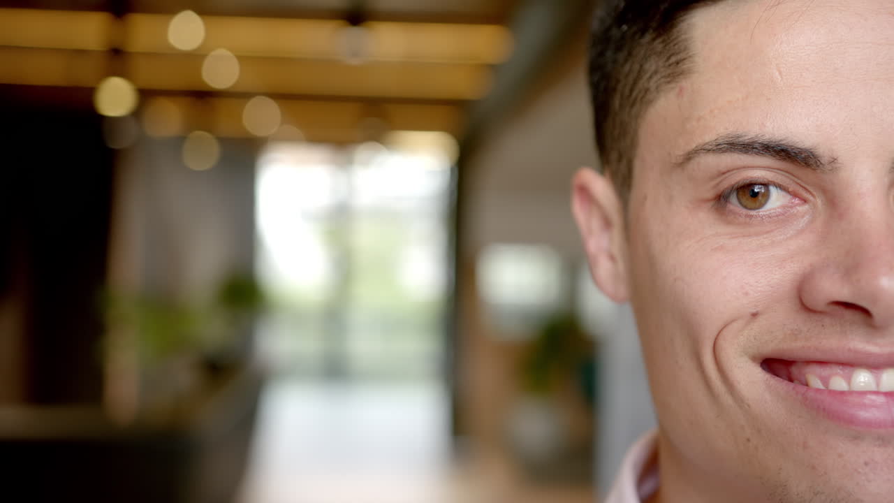 Smiling man in office setting, focusing on work and feeling confident, copy space