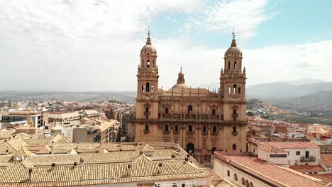 Spain-Jaen-Cathedral,-Catedral-de-Jaen,-flying-shoots-of-this-old-church-with-a-drone-at-4k-24fps-using-a-ND-filter-also-it-can-be-seen-the-old-town-of-Jaen