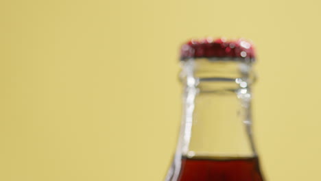 Pull-Focus-Close-Up-Shot-Of-Condensation-Droplets-On-Neck-Of-Revolving-Bottle-Of-Cold-Beer-Or-Soft-Drink-With-Metal-Cap