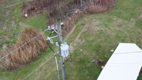 Aerial-orbit-of-a-KU-electrical-distribution-structure-with-lots-of-equipment-like-polymer-insulators,-transformer,-cotter-keys,-guy-wire,-fuses-and-ect