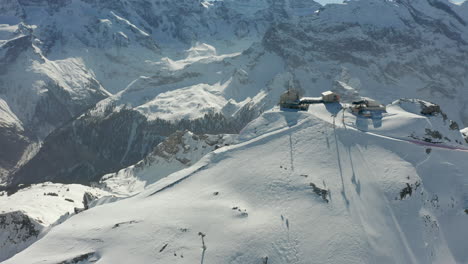 Aerial-of-ski-lifts-going-up-and-down-snow-covered-mountain