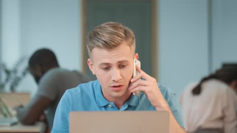 Angry-man-talking-phone-at-coworking-.-Closeup-man-discussing-work-questions.