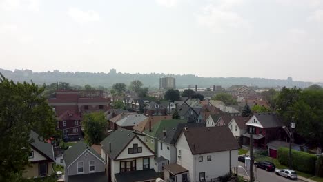 Ascending-drone-shot-of-Residential-area-of-Hamilton-City-during-foggy-and-sunny-day-in-Canada