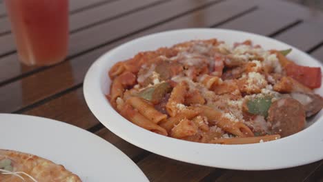 top view of pasta, pizza and cocktail drinks on a table