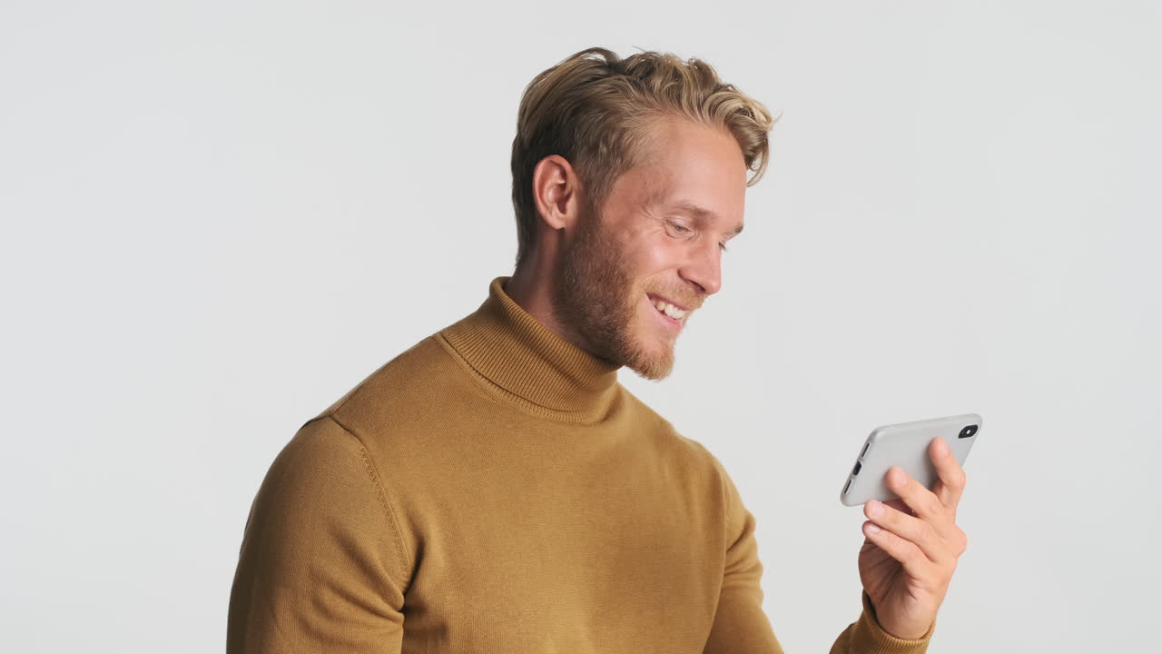 Smiling man watching video