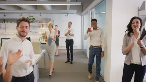 Congratulations-businessman-receiving-praise-as-team-members-clap-in-applause-celebrating-victory-on-return-to-office-slow-motion-walk-POV-shot-concept-series