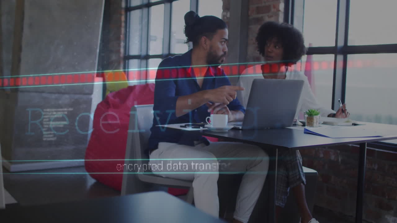 Encrypted data transfer animation over two people discussing work at laptop