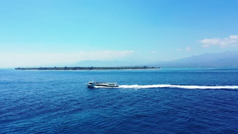 Luxury-Pleasure-Sailing-Yacht-Sails-Past-Tropical-Island,-summer-holiday-luxury-vacation-concept