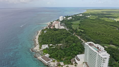 cozumel mexico aerial v21 establishing shot drone flying along the island shoreline over beachfront holiday hotels, resorts and golf course with beautiful seascape - september 2020